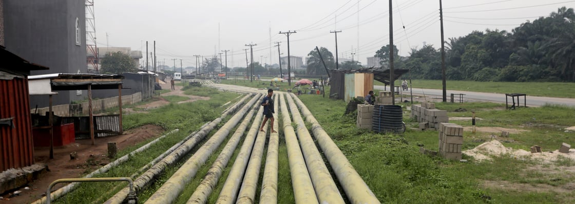 FILE PHOTO: A woman walks over pipelines crisscrossing Ogoniland in Rivers State, Nigeria September 18, 2020. Picture taken September 18, 2020. REUTERS/Afolabi Sotunde/File Photo