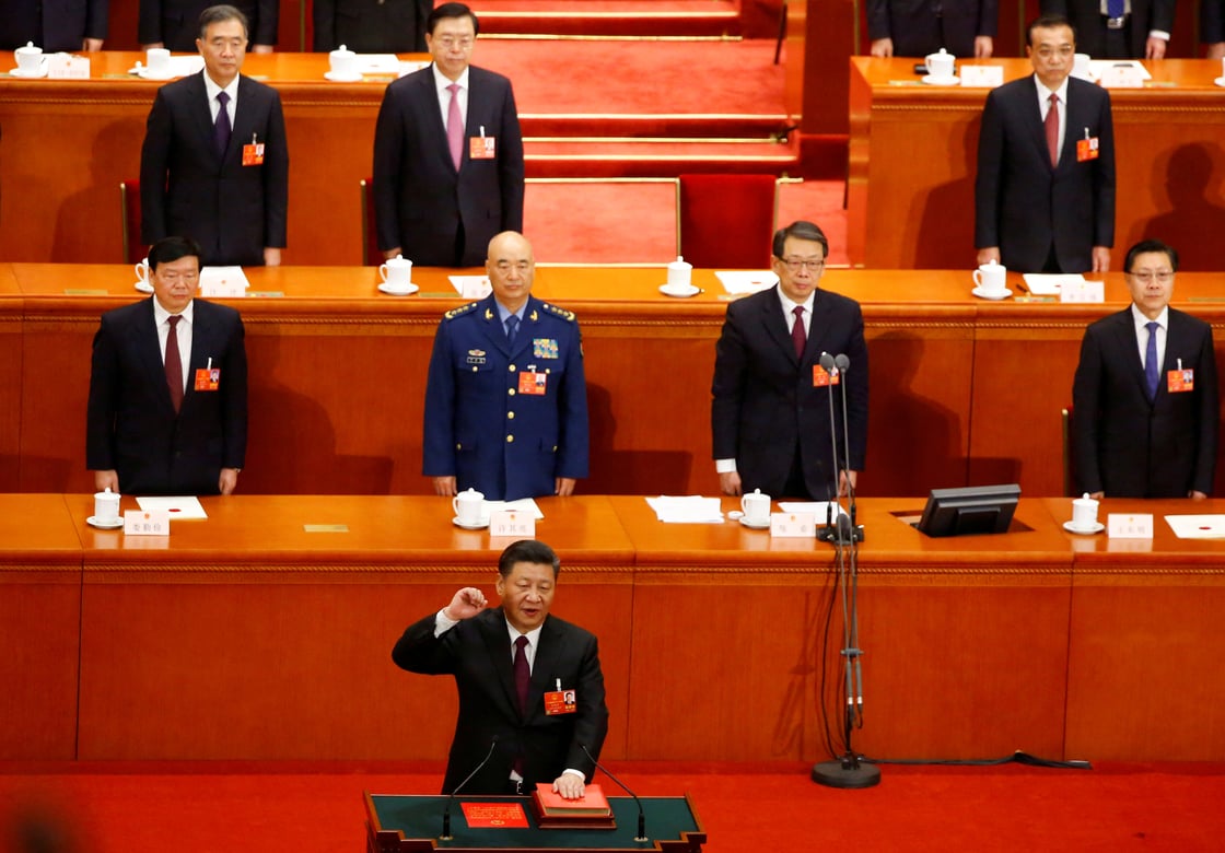 Xi Jinping speaks at podium.