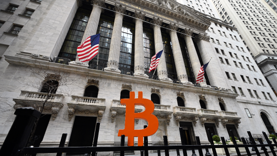 A Bitcoin currency emblem made by artist Leonid Sukala is placed along the security gate in front of the New York Stock Exchange