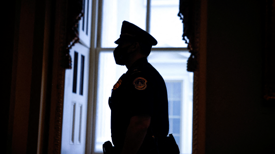 A Capitol police officer stands in the Capitol on the eve of the Jan 6 anniversary