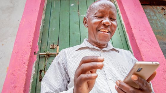 A Kenyan farmer who uses digital technology services via a smartphone