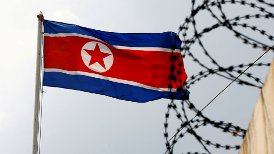 A North Korea flag flutters next to concertina wire at the North Korean embassy in Kuala Lumpur