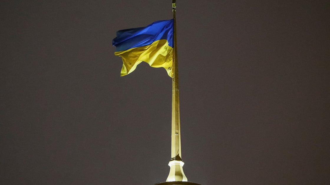 A Ukrainian national flag flies over the parliament building