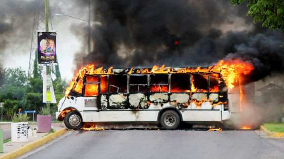 A burning bus, set alight by cartel gunmen to block a road, is pictured during clashes with federal forces following the detention of Ovidio Guzman