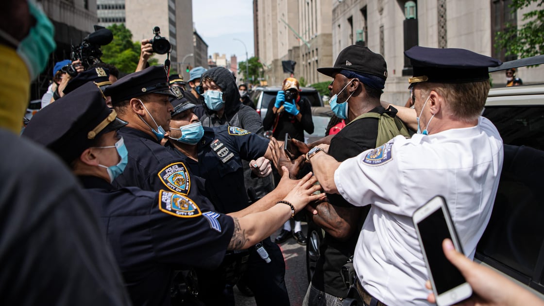 A demonstrator is arrested by police at a We Cant Breathe rally in protest over the death of George Floyd