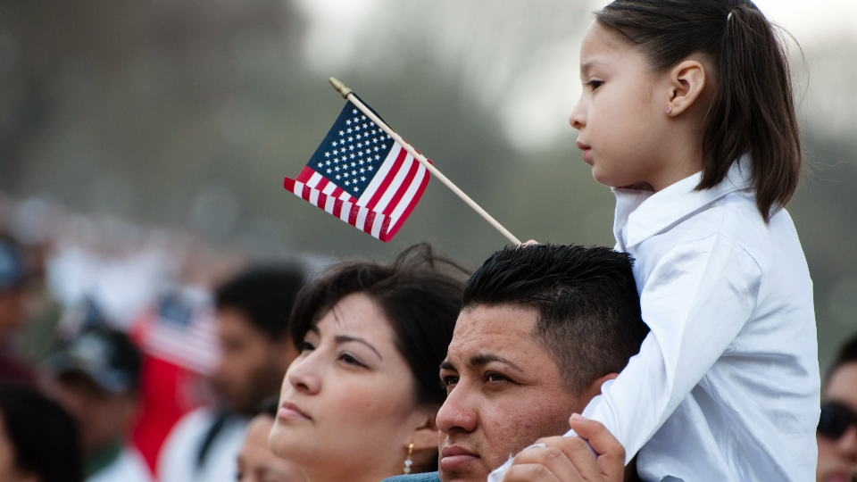 A girl and her father stand with some 200,000 immigrants rights activists demand comprehensive immigration reform in Washington D.C.