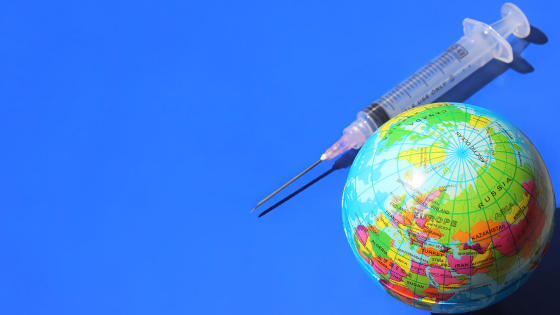 A globe and syringe on a blue background