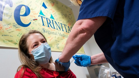 A healthcare worker gets vaccinated at the Trinitas Regional Medical Center in Elizabeth