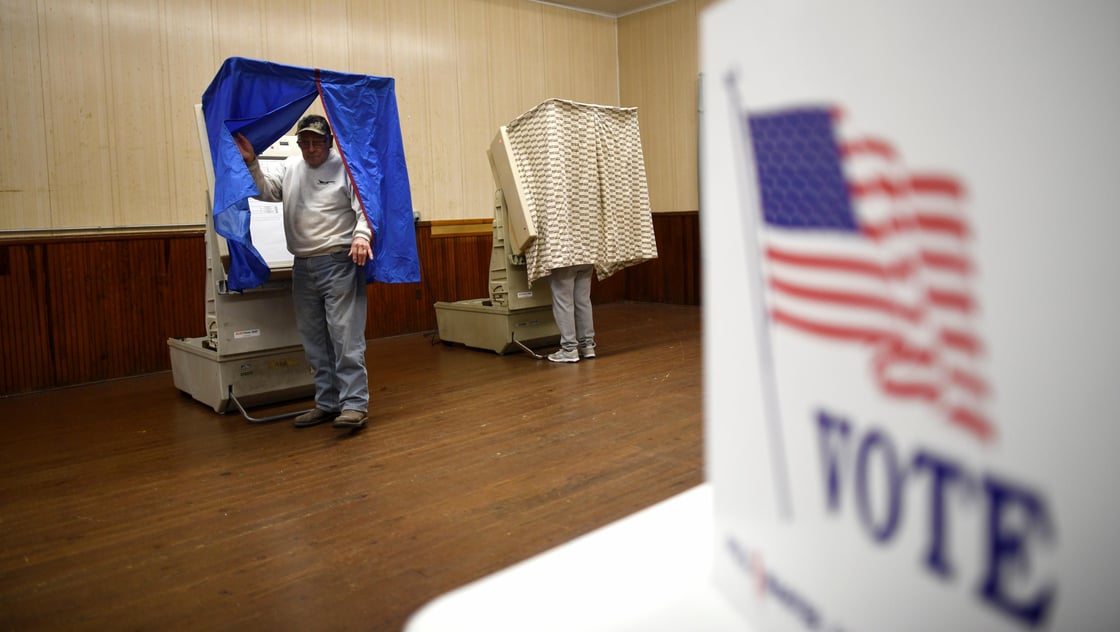 A man exits the voting booth after casting his ballot at Pillow Boro Hall in state and local elections in Pillow, Pennsylvania