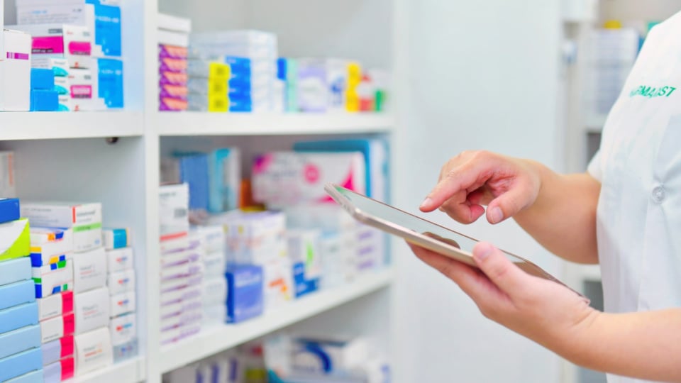 A medical professional checks inventory of medication drugs. (1)