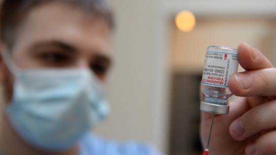 A medical worker prepares a syringe with a dose of the Moderna COVID-19 vaccine