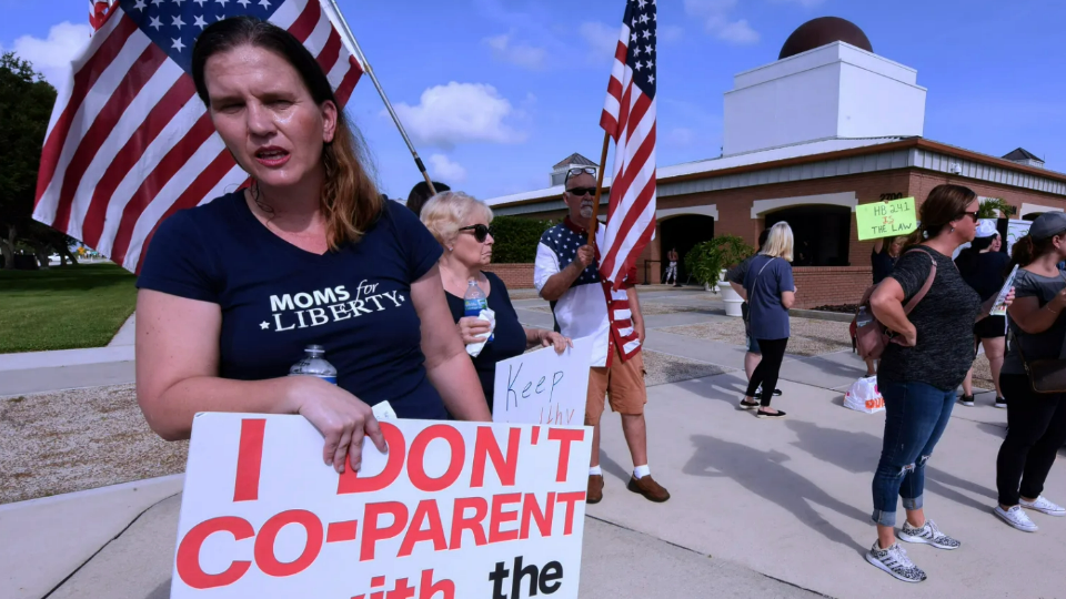 A member of Moms for Liberty protests against mandatory face masks for students during the COVID-19 pandemic 