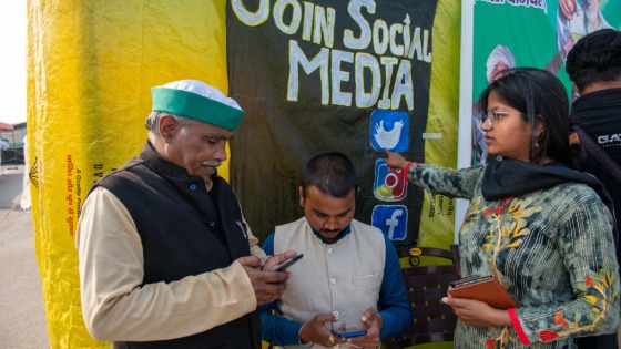 A member of the All India Student Federation teaches farmers about social media