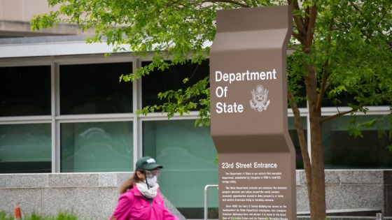 A pedestrian walks by the State Department in Washington