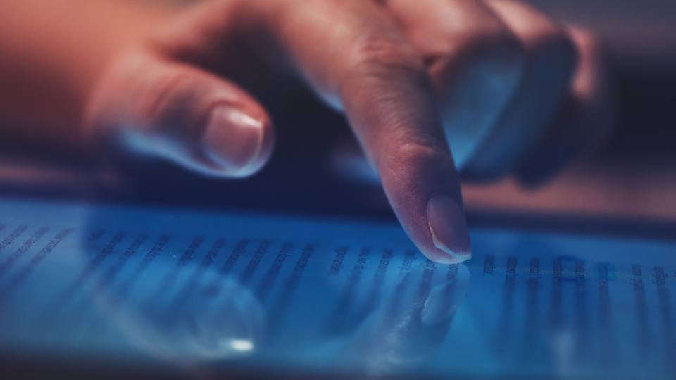 A person scrolls through a news article on their tablet.