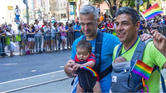 A same-gender couple and their babies walk in the San Francisco pride parade in 2013