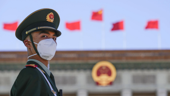 A security official wearing a face mask amid COVID concerns stands guard