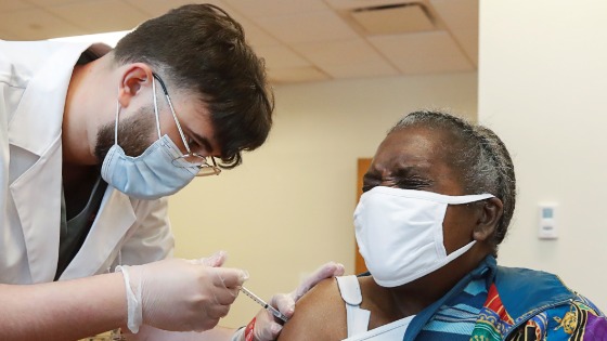 A senior citizen receives an injection of a COVID-19 vaccine