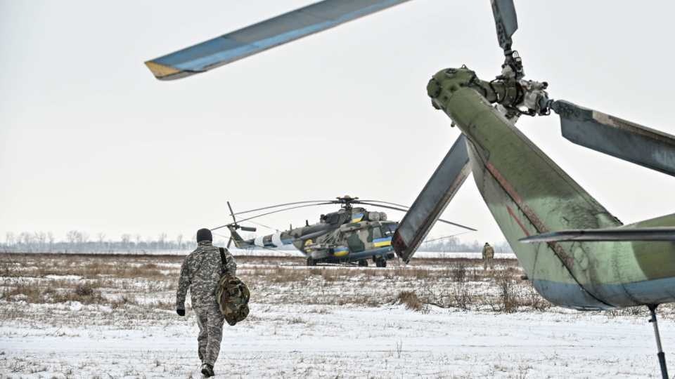 A serviceman of the 11th separate army aviation brigade Kherson of the Armed Forces of Ukraine approaches a helicopter,