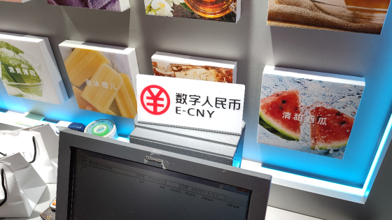 A sign advertising the ability to pay with E-CNY, China’s central bank digital currency, is seen at a store Shenzhen