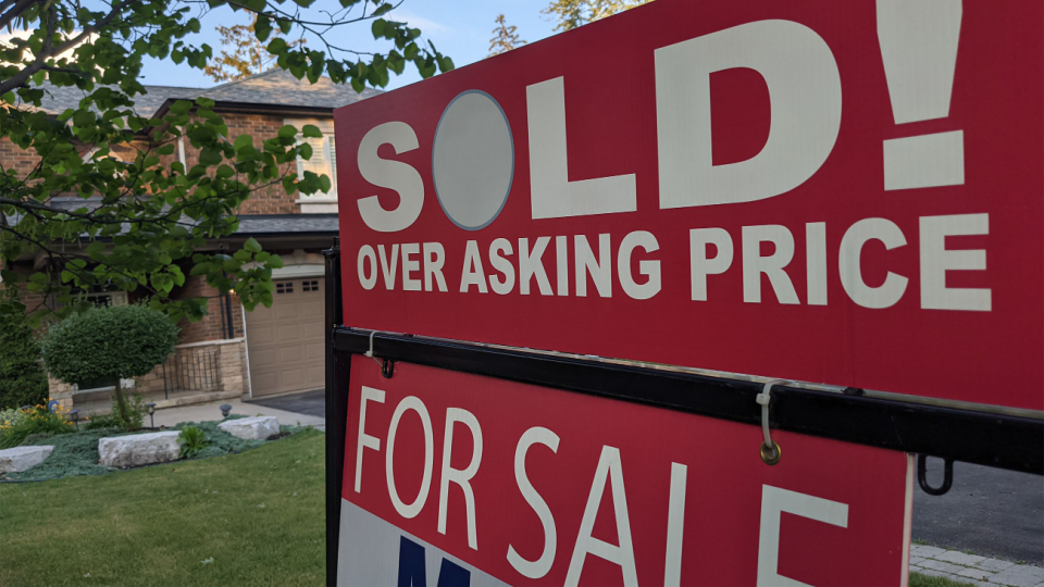 A sign outside a home says it has been sold for over the asking price