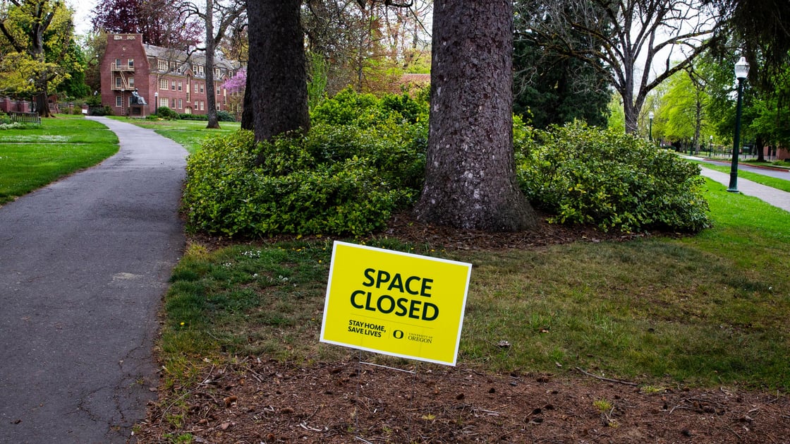 A sign warns visitors the public spaces on campus at the University of Oregon