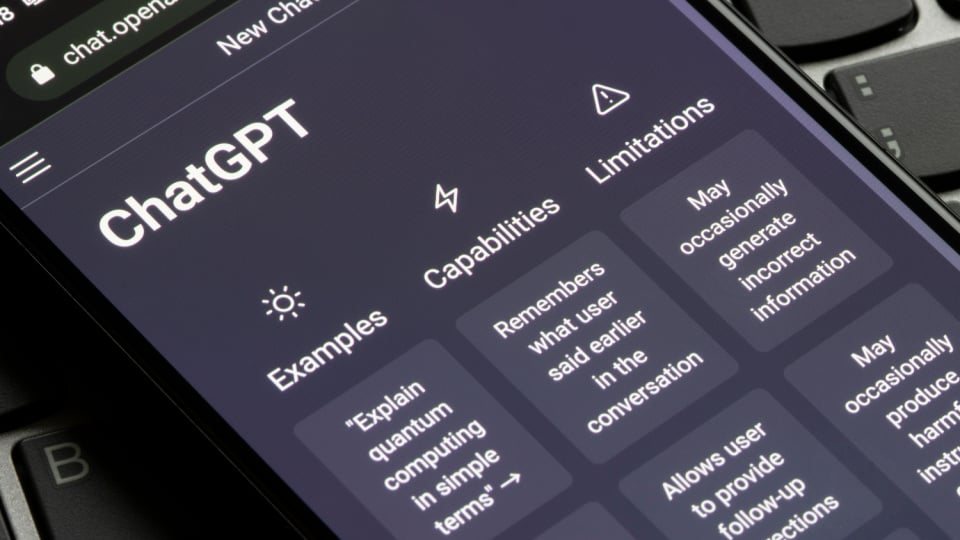 A smartphone screen shows ChatGPTs examples, capabilities, and limitations