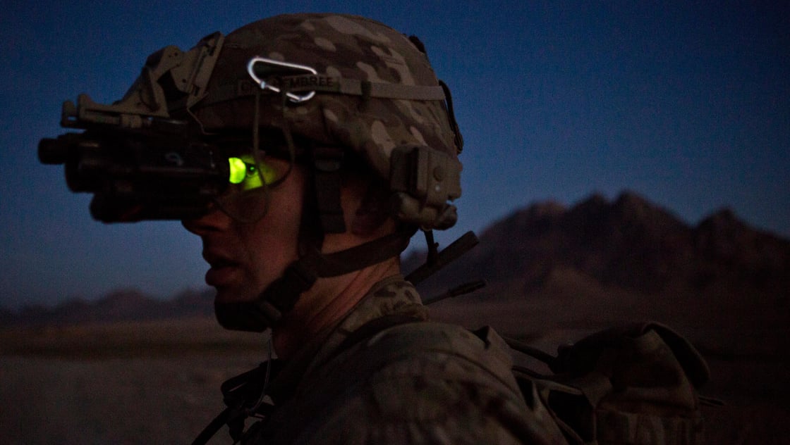 A soldier from the U.S. Army 1st Platoon, Alpha Company, 1st Battalion, 36th Infantry Regiment, uses night vision goggles as soldiers meet with members of the Afghan local police at a checkpoint