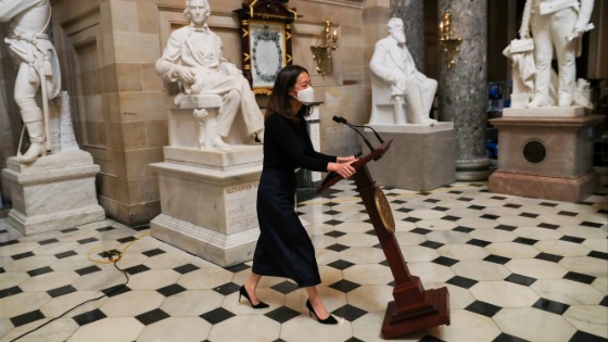 A staff member moves Nancy Pelosis lectern for impeachment trial