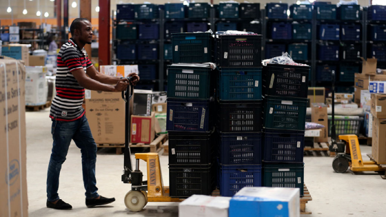 A staff member of online retailer Jumia pushes a cart loaded with goods at the company warehouse