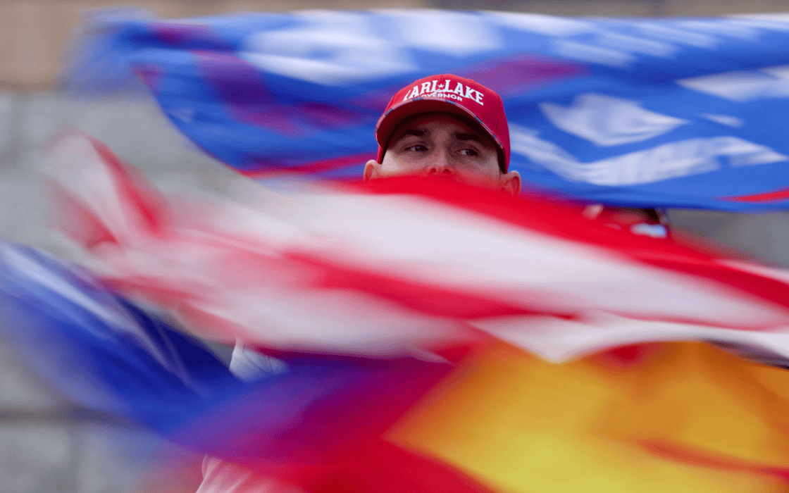 A supporter of defeated Republican candidate for Arizona Governor Kari Lake protests outside the Arizona State Capitol, in Phoenix, Arizona