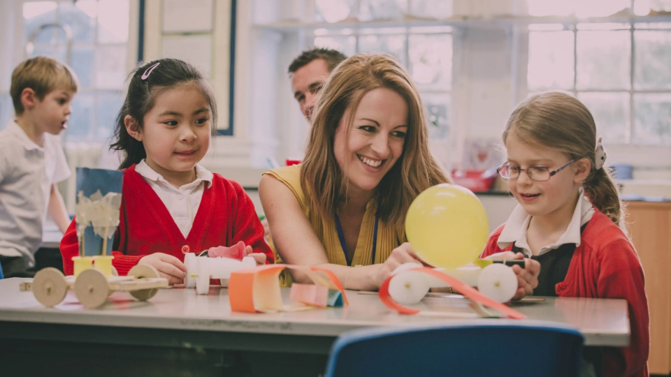 A teacher provides instruction to her students