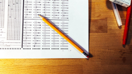 A top-down view of a multiple-choice test on white paper and a pencil