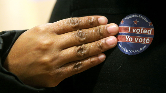 A voter wears a bilingual I voted sticker at the University of the District of Columbia