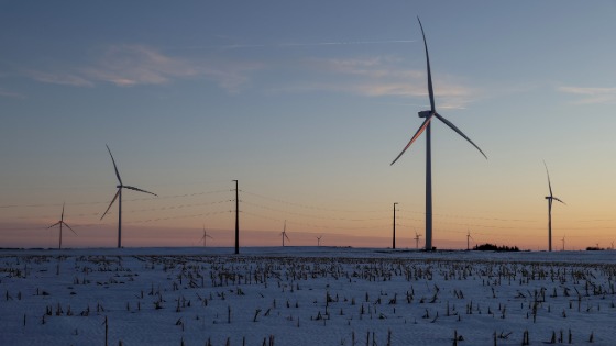 A wind farm shares space with corn fields the day before the Iowa caucuses