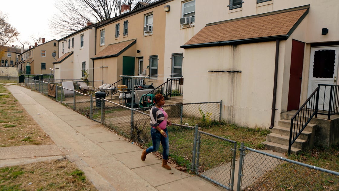 A woman walks on a path in the Berry Farm housing project in Ward 8 of Washington November 20, 2012