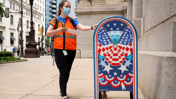 A woman wearing a mask to prevent the spread of COVID-19 casts her ballot in the primary election in Philadelphia,