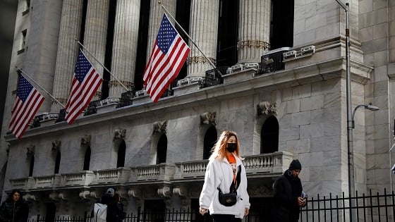 A woman wears a mask near the NYSE in the Financial District in New York