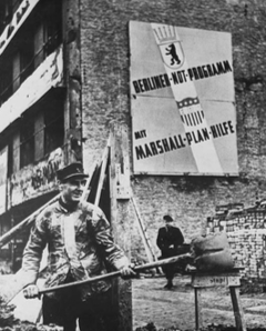 A worker in West Berlin, Germany, 1951. The sign reads, Berlin Emergency Program, with Marshall Plan aid