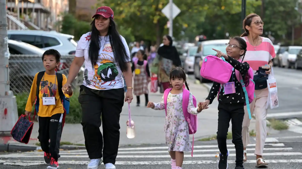 Accompanied by family members, children arrive back to school on the first day of the 2024-2025 City Public School year in Queens