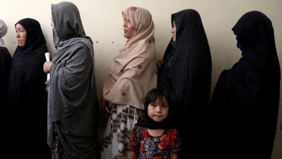 Afghan women line up at a polling station as they wait to cast their votes in Kabul