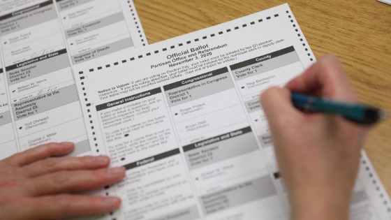 An election official creates a duplicate absentee ballot