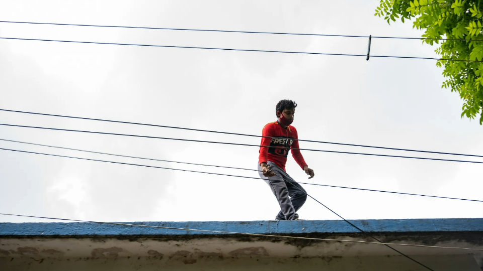 An employee of an Internet wired broadband service provider is providing internet connection through Internet Cable at Tehatta, West Bengal