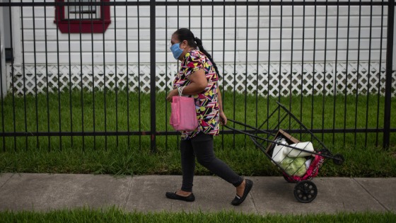 Antonia walks home with groceries distributed by the Wesley Community Center