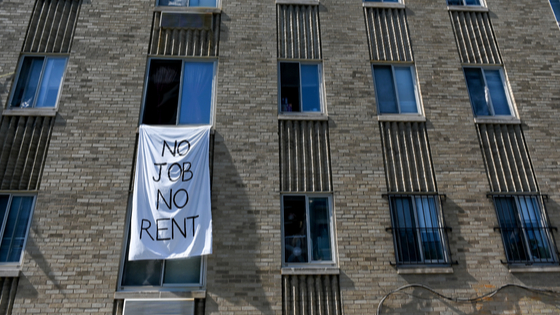 Apartment building with sign in window amid COVID-19.