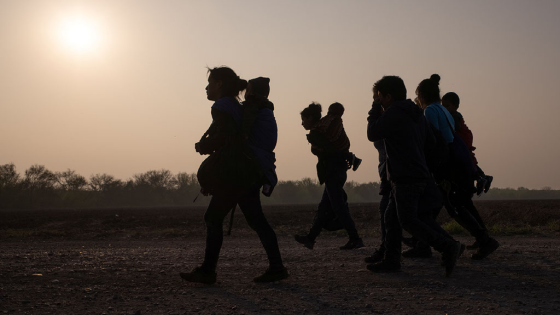 Asylum-seeking mothers from Guatemala and Honduras carry their children after they crossed the Rio Grande river