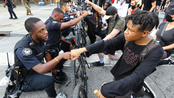 Atlanta Police officer J. Coleman and protester Elijah Raffington give each other a fist bump