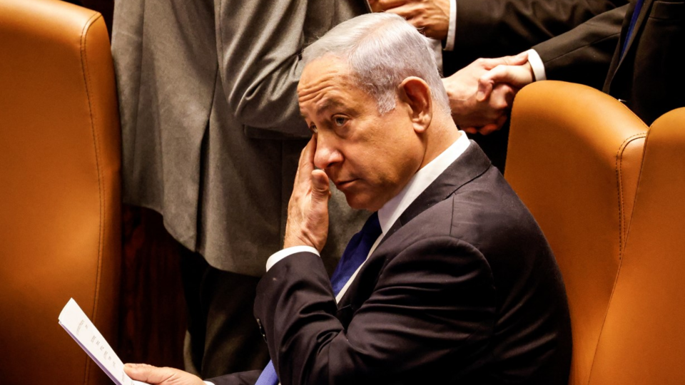 Benjamin Netanyahu looks on as Israeli lawmakers vote on a bill that would limit some Supreme Court power