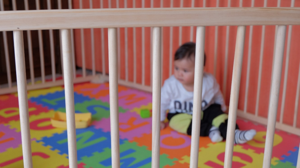 Blurry shot of baby in playpen