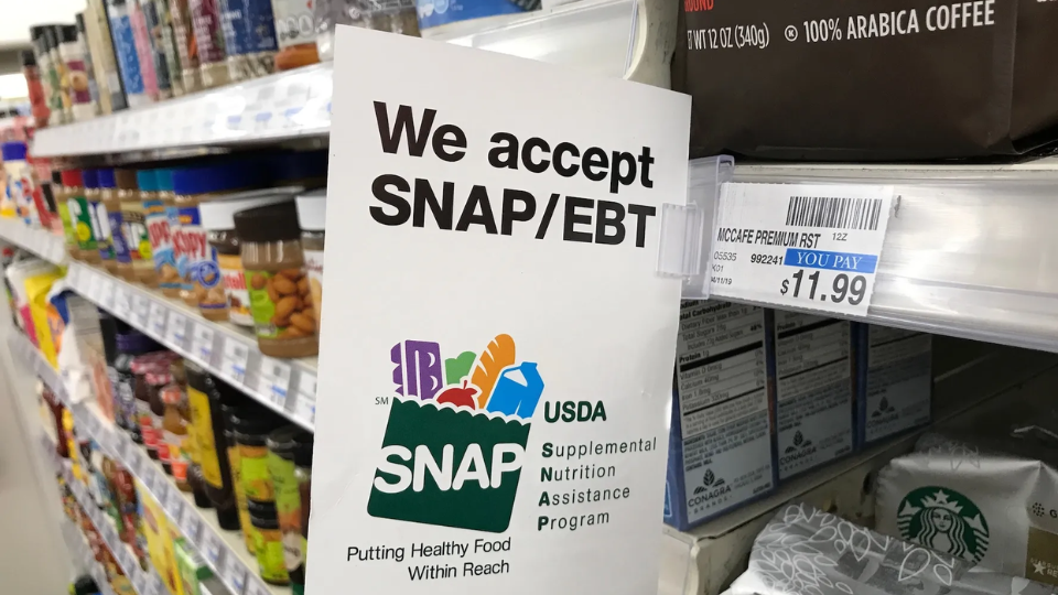 Image depicting a SNAP sign in a grocery store.